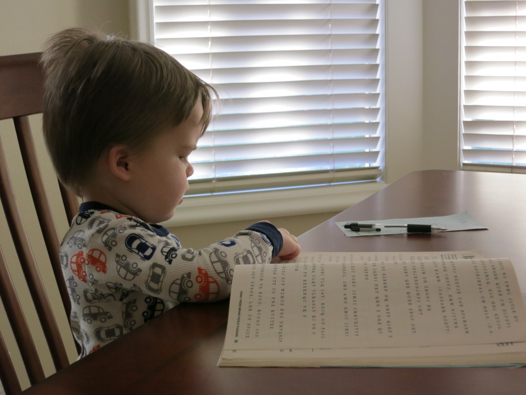 Emrick flips through one of Grandma's puzzle books.