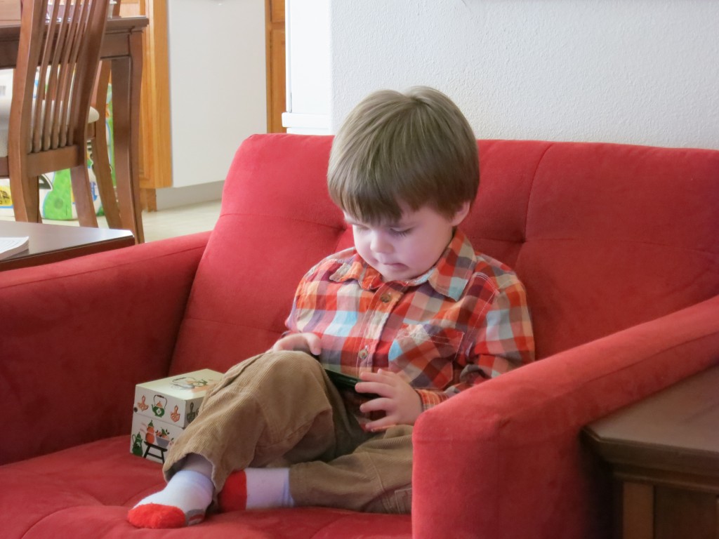 Emrick hangs out in one of G+G's red chairs. Next to him is Grandma's old, old, OLD recipe box. 