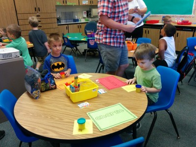 Here's Emrick sitting at his assigned table. He and the other kids were a little uncertain at first if it was ok to start playing with the can of play-doh each was given. It was!